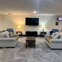 New carpet and comfortable furniture in DevonHouse's sitting room.